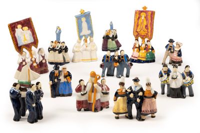 a group of figurines of people dressed in historical costumes