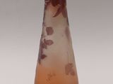 a glass vase with a brown and white design on it