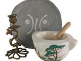 a bowl with a wooden spoon in it next to a bowl with a spoon in it