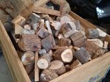 a wooden box full of chopped wood in a warehouse