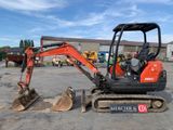 a small excavator that is parked in a parking lot