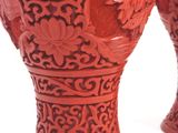 two red vases sitting next to each other on a table