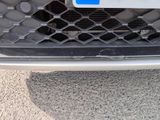 a close up of a car ' s grille with a number plate on it