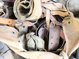 a pile of old belts and other items on the floor