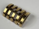 a close up of a gold ring on a white surface