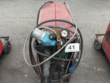 three lawn mowers that are parked in a parking lot