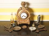 a clock sitting on top of a table next to other items