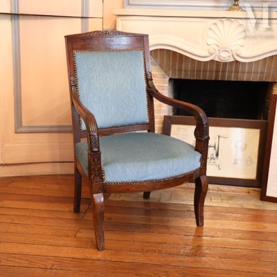 a chair that is sitting in front of a fireplace