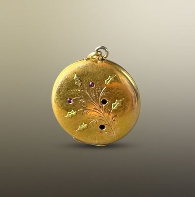 yellow gold locke with pink sapphires on a gray background