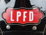 a close up of a black motorcycle with a red label on it