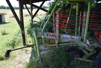 a tractor that is parked next to a fence