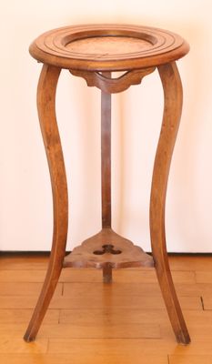 a small wooden table with a glass top on a hard wood floor