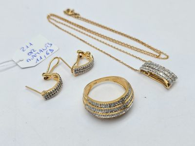 a close up of a necklace, ring, and earring on a table