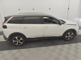 the white car is parked in the garage of the building
