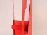 an image of a red chair sitting on top of a white floor