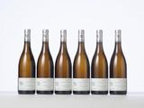 six bottles of white wine lined up in a row
