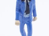 a figurine of a man in a blue suit and tie