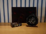 a picture of a black and white vase and a small box on a table