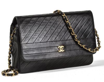 a black chanel bag with a gold chain strap