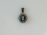 a close up of a small pendant with a face on it