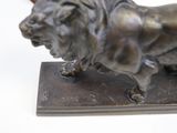 a statue of a lion on a base on a white background