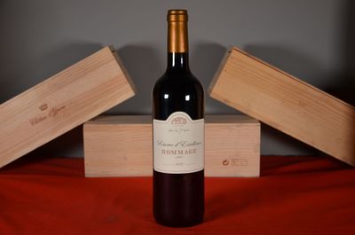 a bottle of wine sitting on a table next to two wooden boxes
