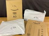 three boxes of amazon boxes sitting on top of a wooden table