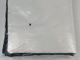 a white sheet wrapped in plastic on a white surface
