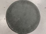 a gray object on the floor with a black object in the middle of it
