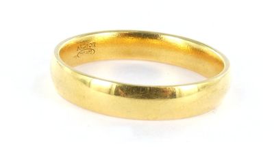 a close up of a gold ring on a white surface