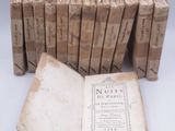 several old books are stacked on top of each other on a table