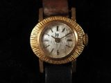 an image of a gold watch on a black background