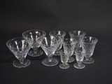 six verres à vin transparents posés sur une table noire