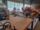 a man sitting at a table with a saw in front of him