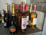many bottles of wine sitting on a shelf in a refrigerator