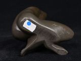 a figurine of a seal with a blue dot on it