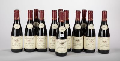six bottles of wine are lined up in a row on a table