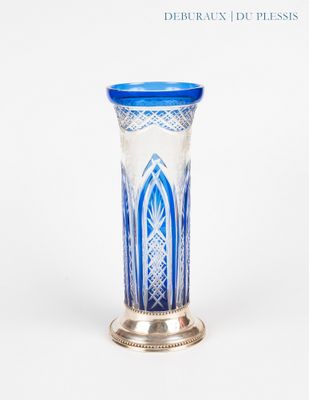 a blue and white vase sitting on a silver stand