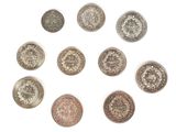 a group of six different coins sitting on top of a white surface
