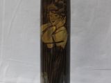 a black and gold lamp with a picture of a woman on it