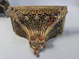 an image of a gold and black box on a white surface