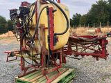 a close up of a tractor with a sprayer attached to it ' s back