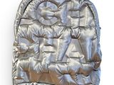 silver backpack with a bow tie on top of it on a white surface