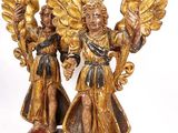 pair of golden angel figurines on a white background