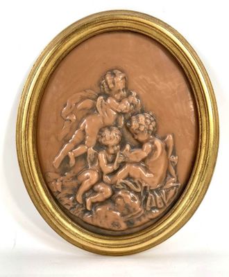 Bas-relief ovale en cire représentant des putti jouant. - Photo 1