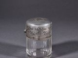 an antique silver plated glass jar with a silver lid