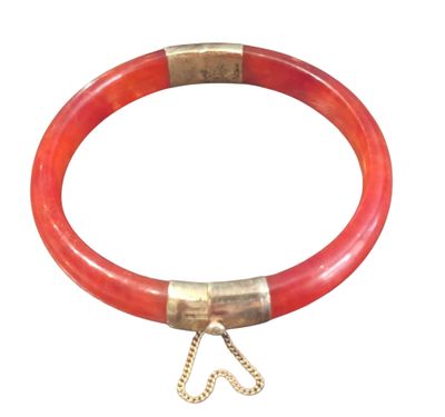 an image of a red bracelet with a gold clasp on a white background