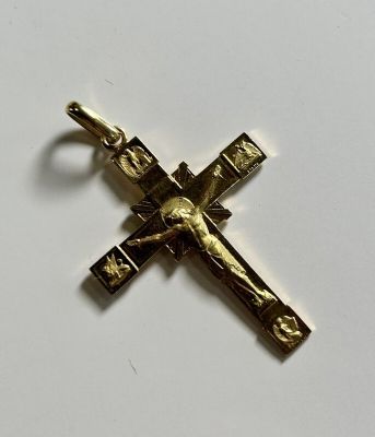 a close up of a cross on a table with a white background