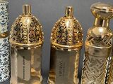 several different types of perfume bottles are lined up on a table