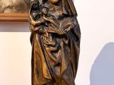 a statue of a woman holding a child on a table